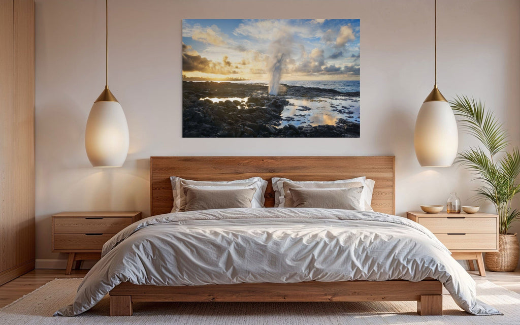 A piece of Kauai art showing a Spouting Horn photo hangs in a bedroom.