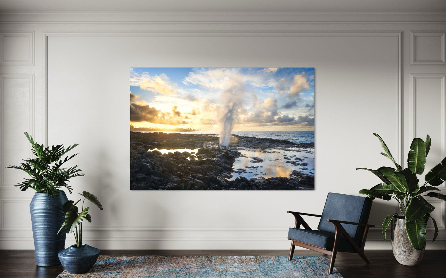 A piece of Kauai art showing a Spouting Horn photo hangs in a sitting area.