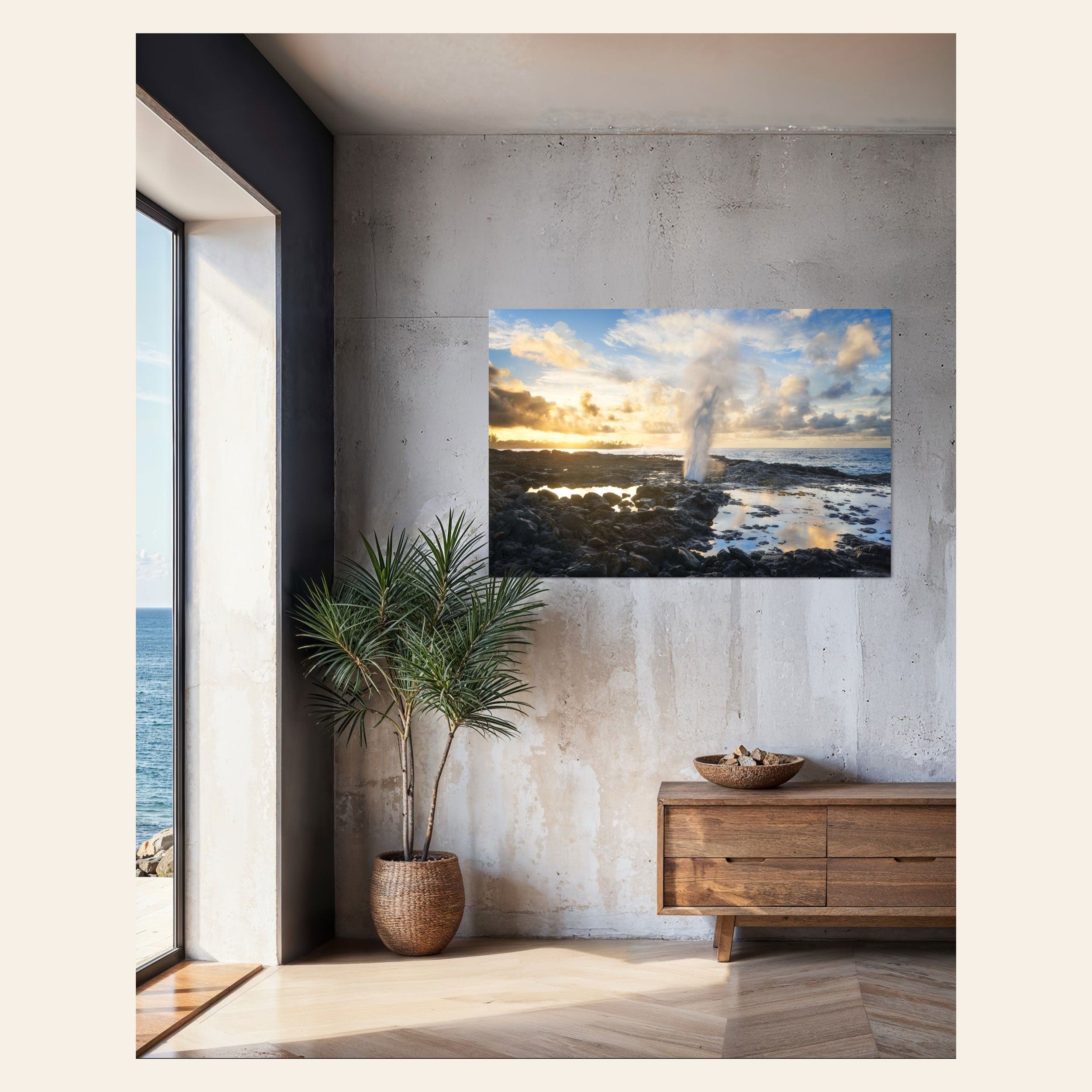 A piece of Kauai art showing a Spouting Horn photo hangs in a living room.