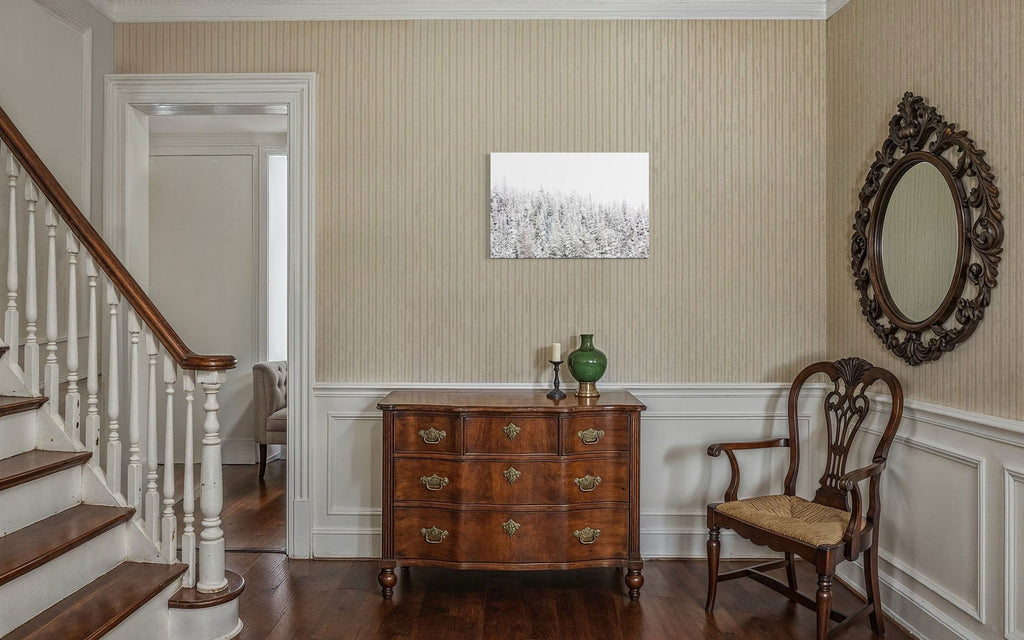 A piece of Steamboat Springs art showing snowy trees outside the Colorado ski resort hangs in a hallway.