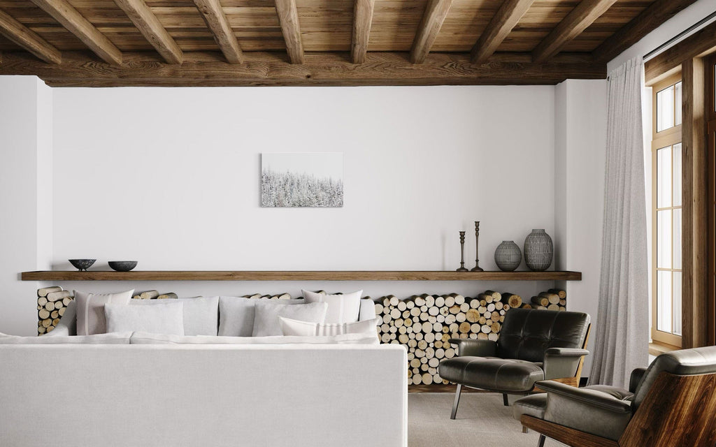 A piece of Steamboat Springs art showing snowy trees outside the Colorado ski resort hangs in a rustic living room.