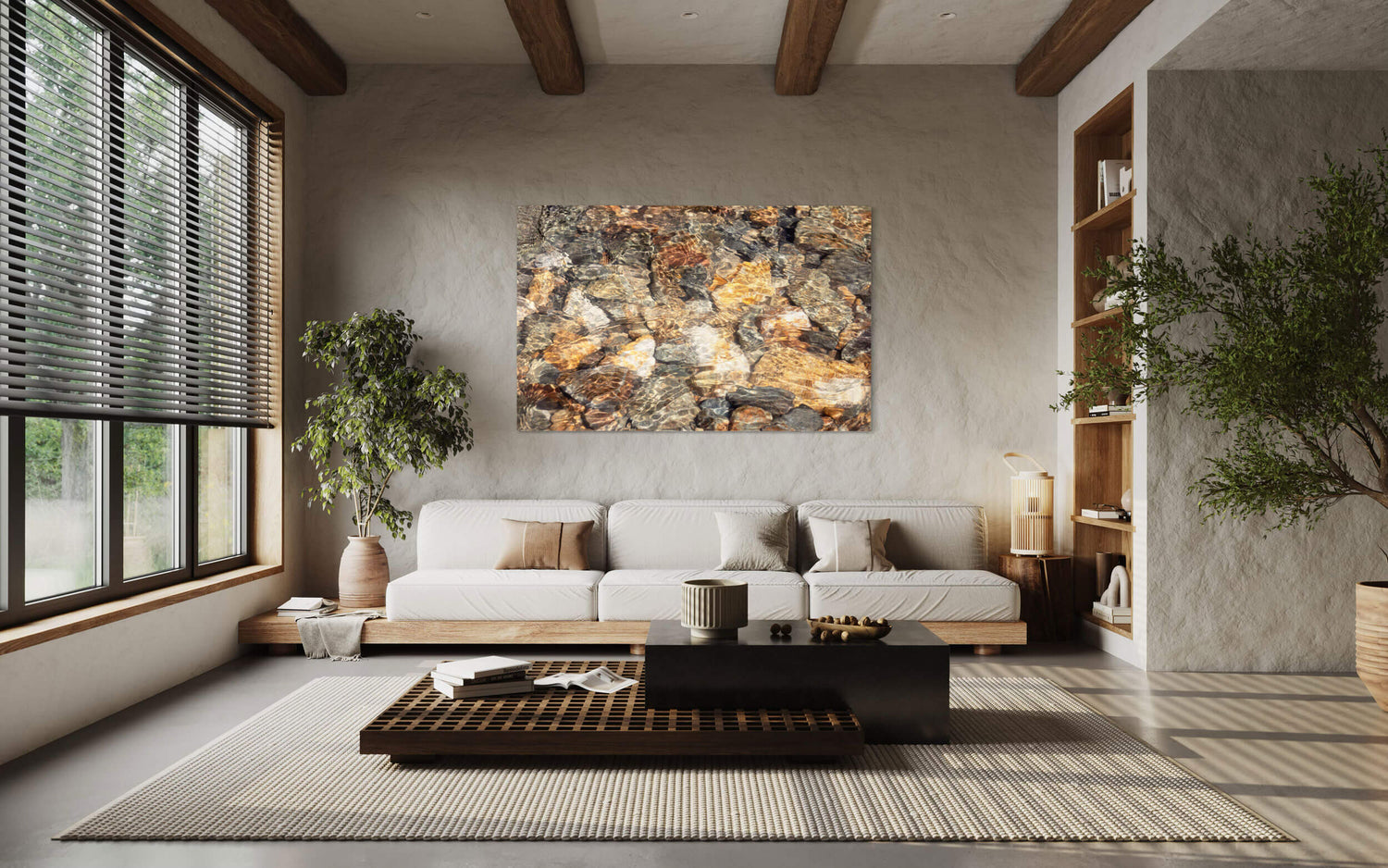 A piece of Telluride art showing glistening rocks in a Colorado River hangs in a living room.