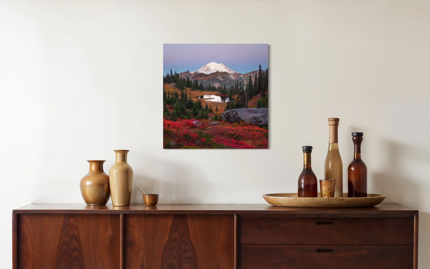 A piece of Mount Rainier art showing a Tipsoo Lake photo hangs over a console.