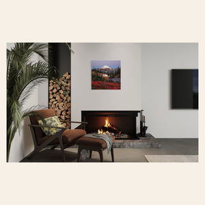 A piece of Mount Rainier art showing a Tipsoo Lake photo hangs over a fireplace.