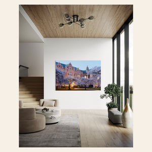 A piece of Seattle art showing the cherry blossoms on the UW campus hangs in a living room.