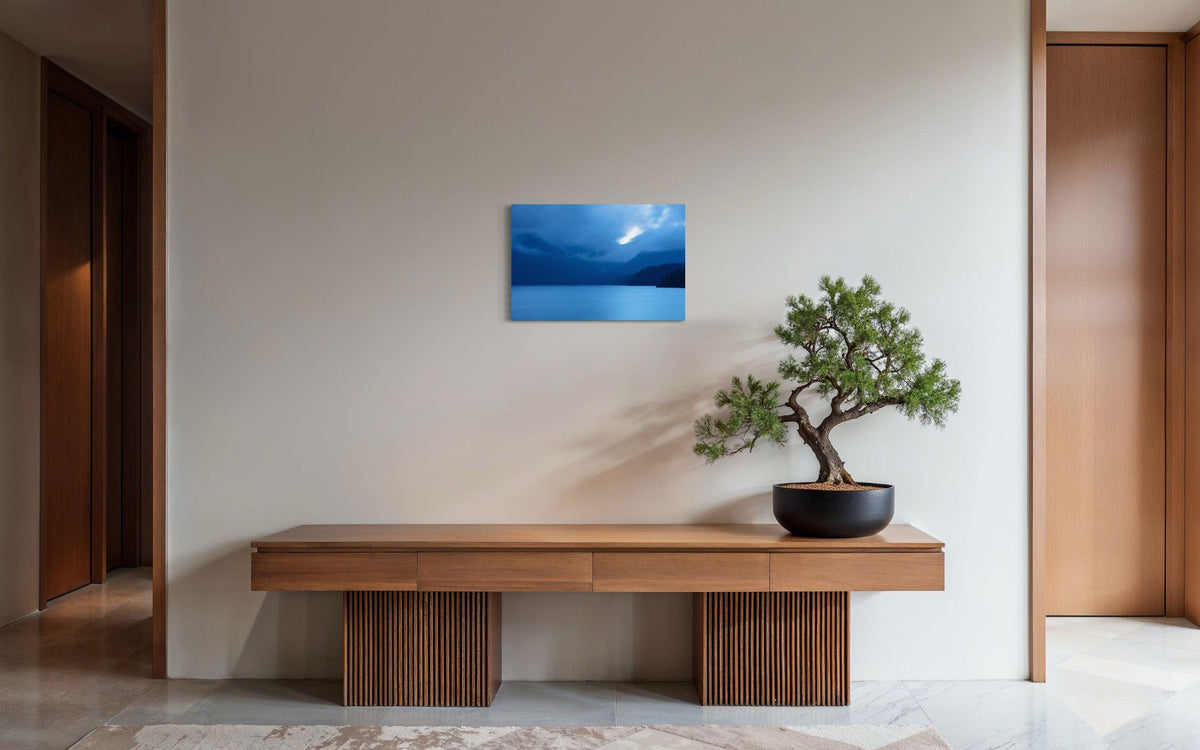 A piece of Vancouver Island art showing a lake photo hangs in a modern entryway.