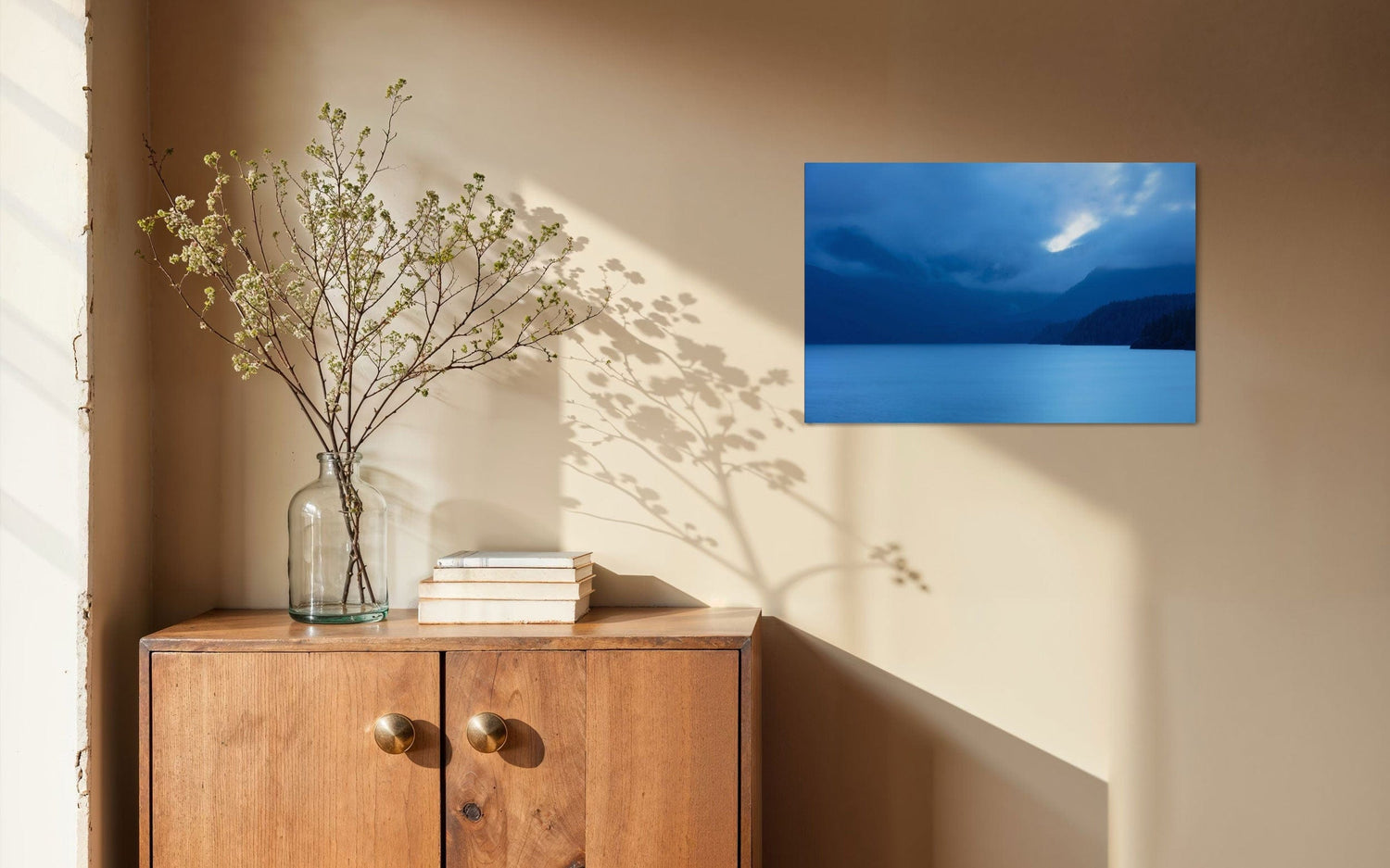 A piece of Vancouver Island art showing a lake photo hangs in a home.