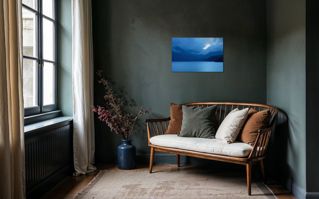 A piece of Vancouver Island art showing a lake photo hangs in a cozy seating area.