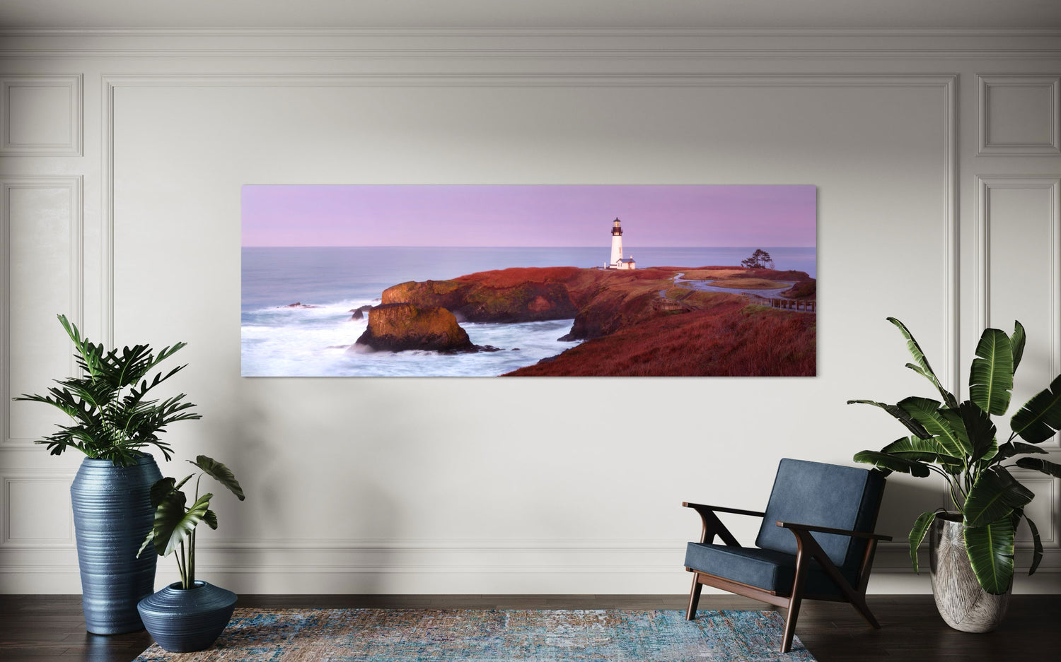 A piece of Oregon wall art showing a Yaquina Head Lighthouse photo hangs in a living room.