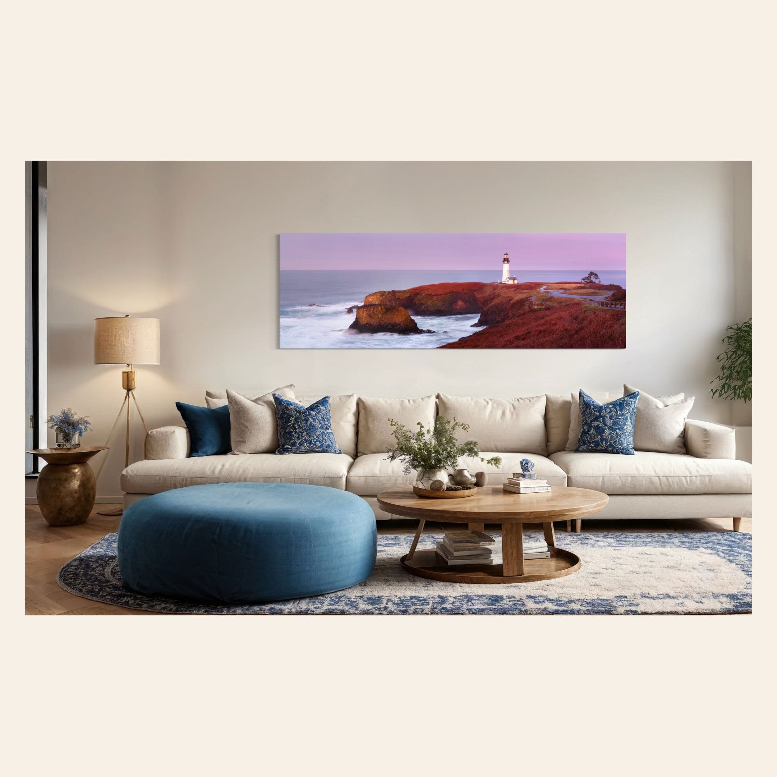 A piece of Oregon wall art showing a Yaquina Head Lighthouse photo hangs in a living room.