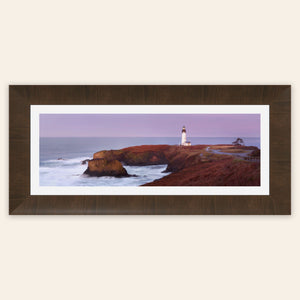 A piece of framed Oregon wall art shows a Yaquina Head Lighthouse photo.