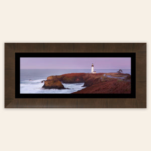 A piece of framed Oregon wall art shows a Yaquina Head Lighthouse photo.