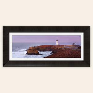 A piece of framed Oregon wall art shows a Yaquina Head Lighthouse photo.