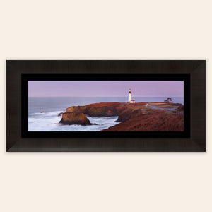 A piece of framed Oregon wall art shows a Yaquina Head Lighthouse photo.