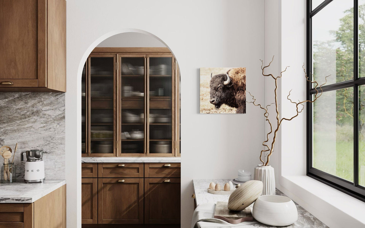 A piece of Yellowstone art showing a photo of a bison hangs in a kitchen.