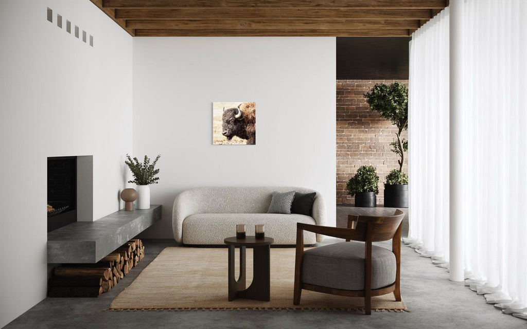 A piece of Yellowstone art showing a photo of a bison hangs in a modern rustic living room.