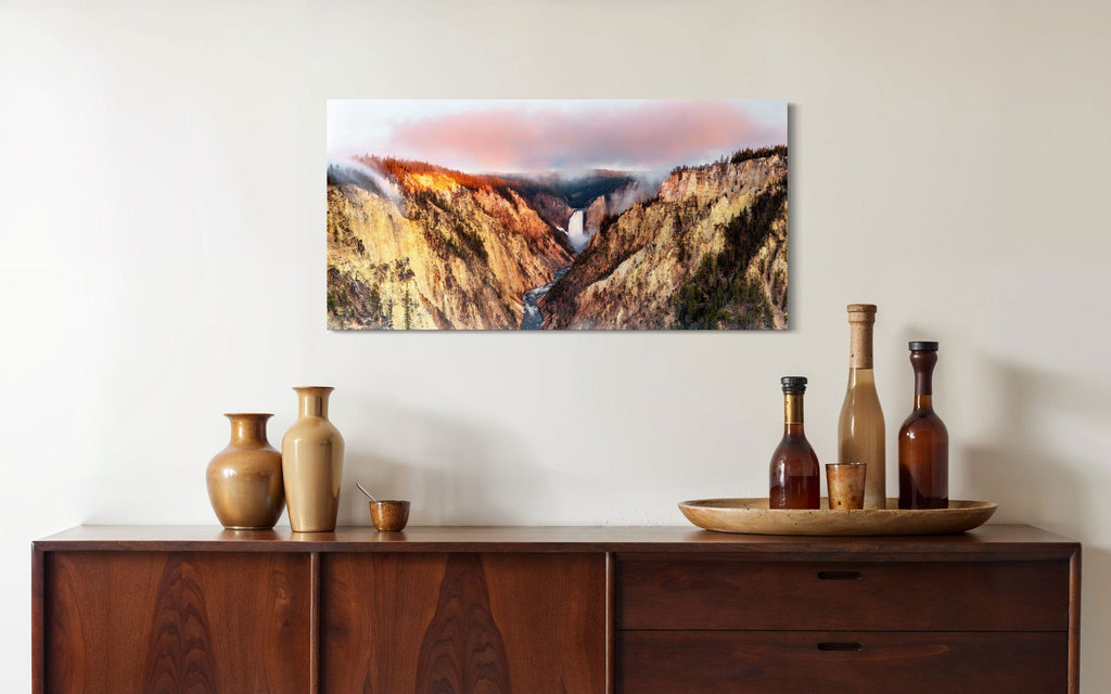 A piece of Yellowstone art showing a canyon photo from Artist Point hangs in a dining area.