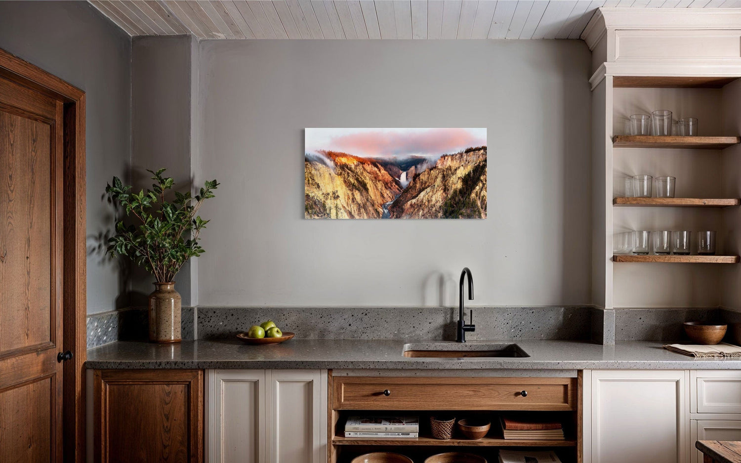 A piece of Yellowstone art showing a canyon photo from Artist Point hangs in a kitchen.