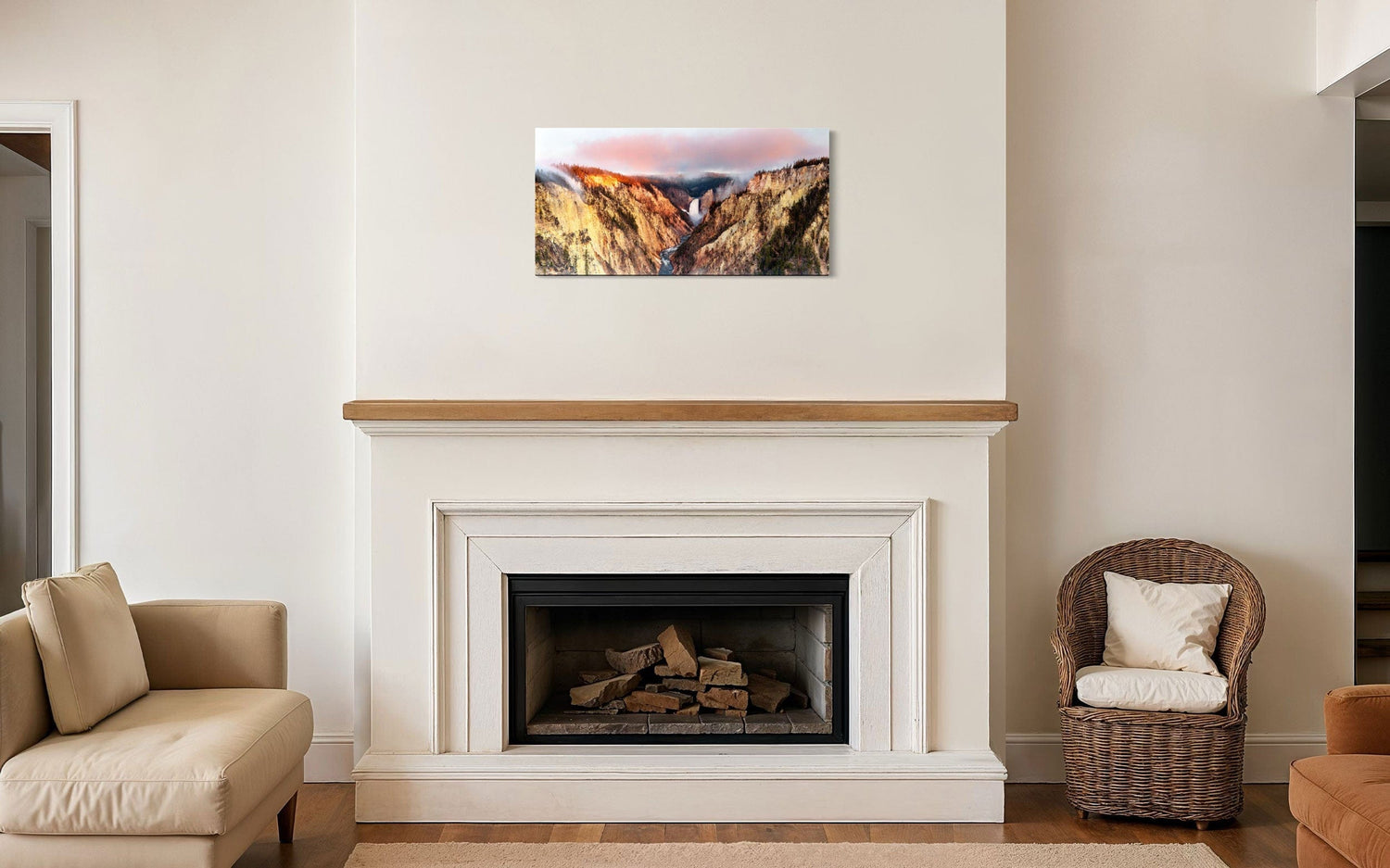 A piece of Yellowstone art showing a canyon photo from Artist Point hangs above a fireplace mantel.