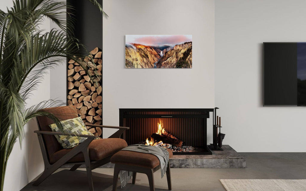 A piece of Yellowstone art showing a canyon photo from Artist Point hangs over a fireplace.