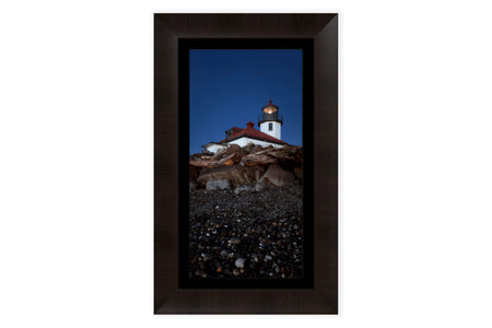 A piece of framed West Seattle art shows the Alki Beach Lighthouse.