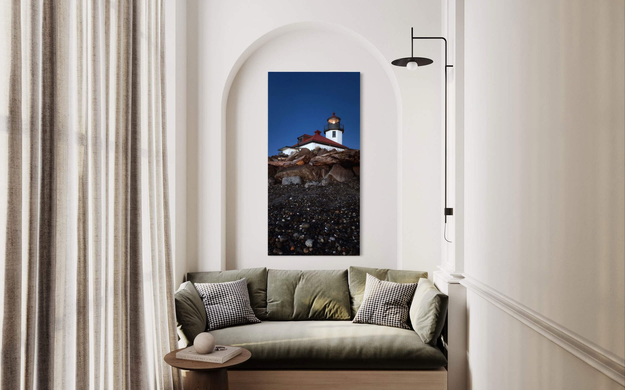 A piece of West Seattle art showing the Alki Beach Lighthouse hangs in a living room.
