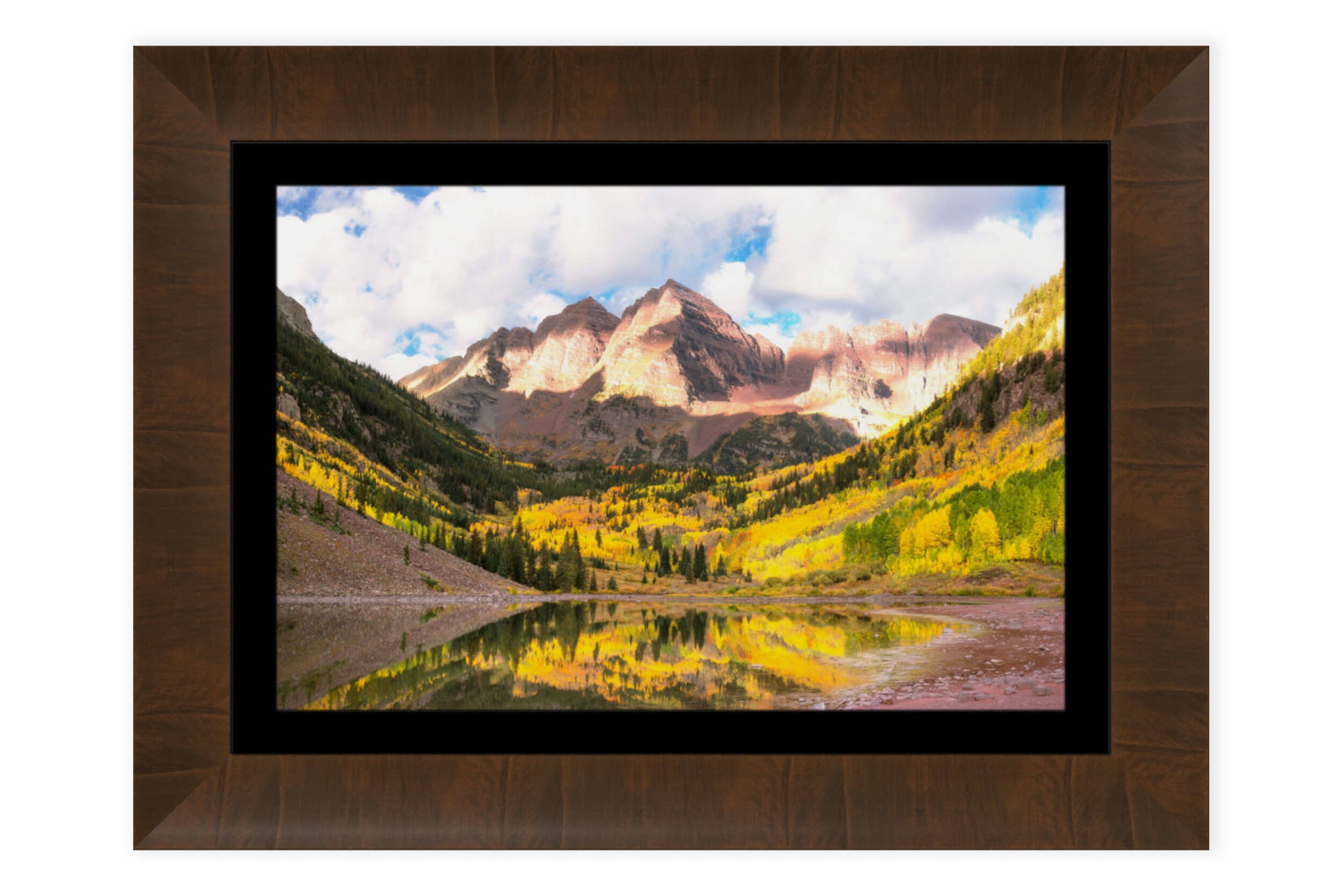 A piece of framed Aspen art shows the Maroon Bells in fall.