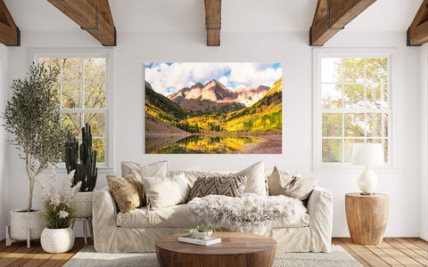 A piece of Aspen art showing the Maroon Bells in fall hangs in a living room.