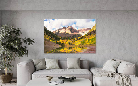 A piece of Aspen art showing the Maroon Bells in fall hangs in a living room.