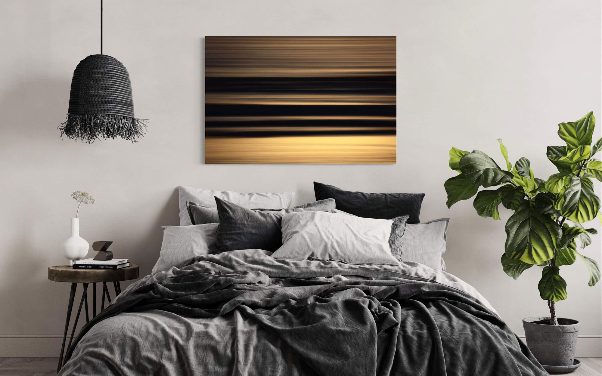 A piece of Cannon Beach art showing an abstract Oregon coast sunset hangs in a bedroom.