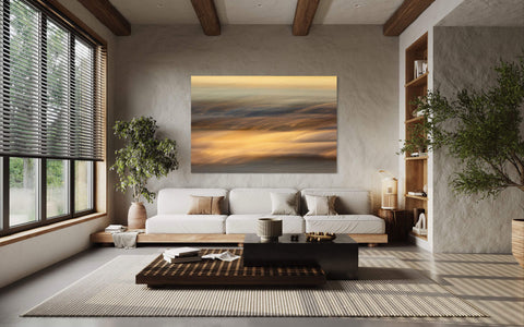 A piece of impressionist Cannon Beach art showing an Oregon Coast sunset hangs in a living room.