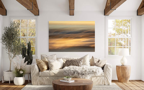 A piece of impressionist Cannon Beach art showing an Oregon Coast sunset hangs in a living room.