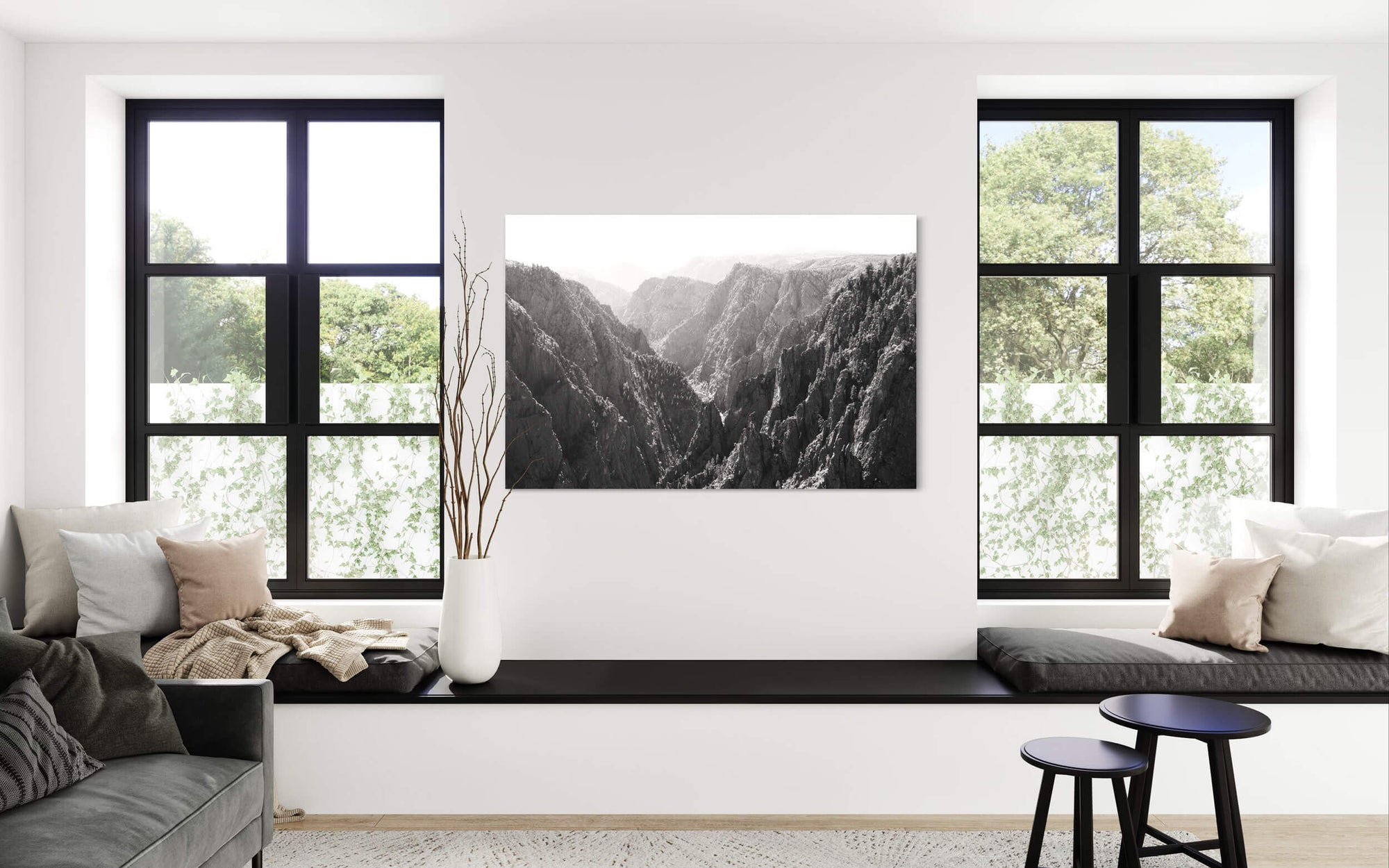 A piece of black and white Colorado art showing the Black Canyon in Gunnison hangs in a living room.