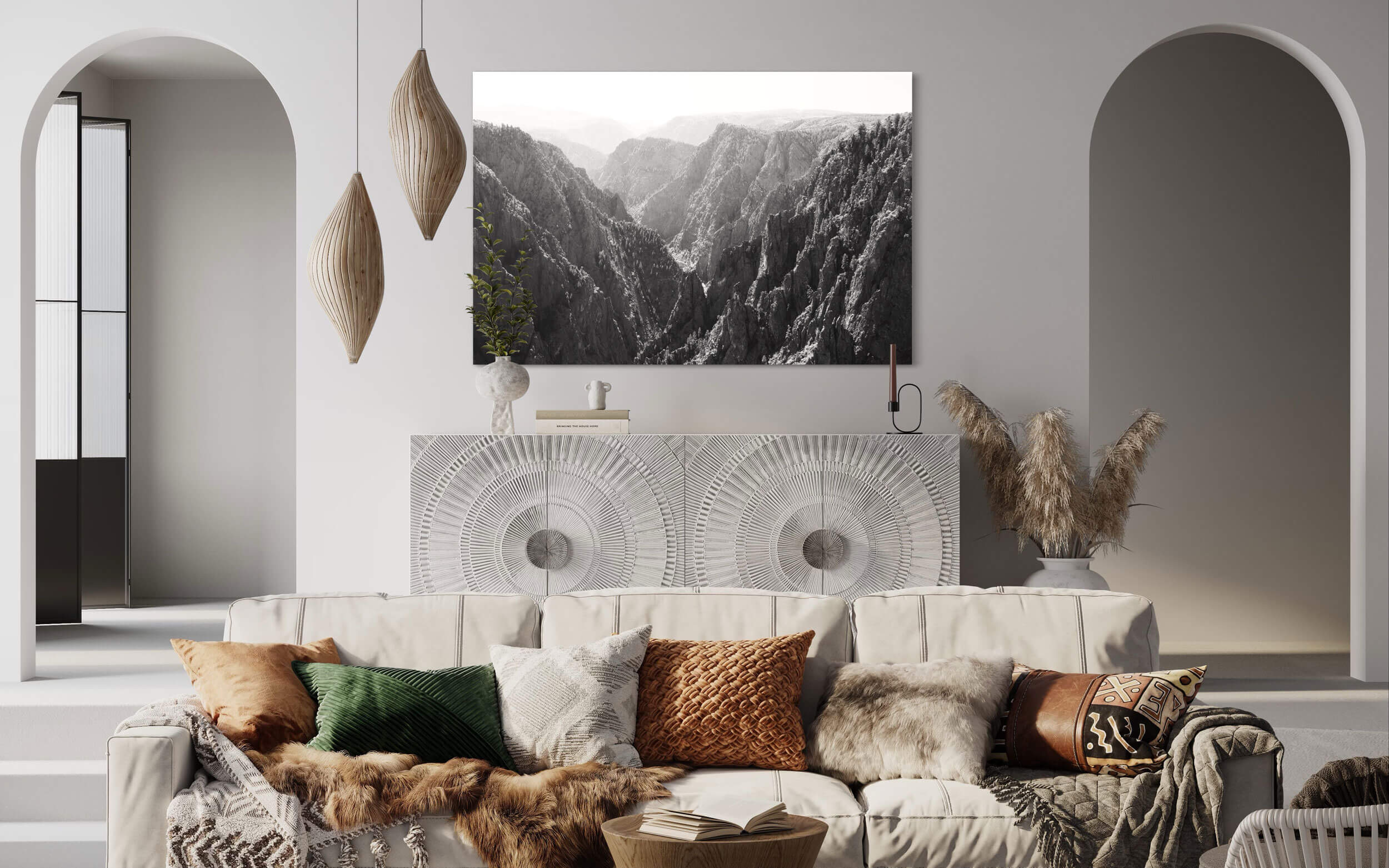 A piece of black and white Colorado art showing the Black Canyon in Gunnison hangs in a living room.