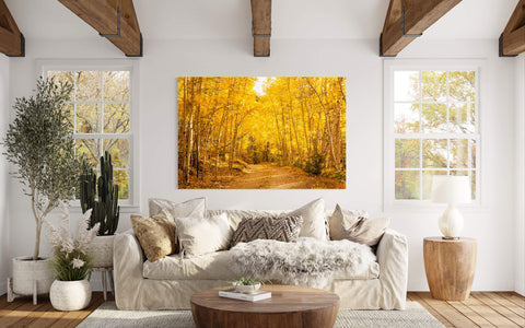 A piece of Colorado art showing Kenosha Pass during peak fall colors hangs in a living room.