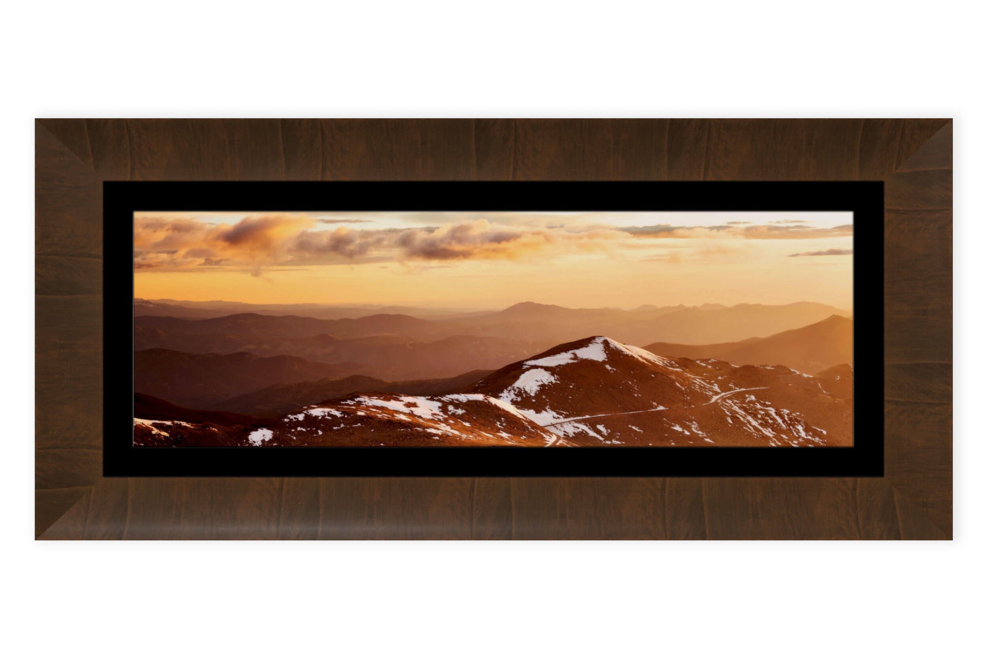 A piece of framed Colorado art shows a sunrise from Mount Evans looking toward Denver.