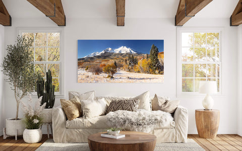 A piece of Colorado art showing Mount Sopris in Carbondale in fall hangs in a living room.