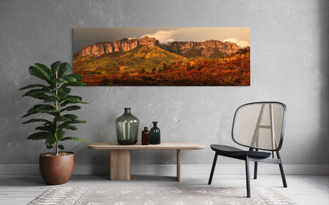 A piece of Colorado art showing the fall colors on Owl Creek Pass hangs in a living room.
