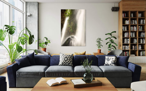 A piece of Colorado art showing the waterfall at Rifle Falls State Park hangs in a living room.