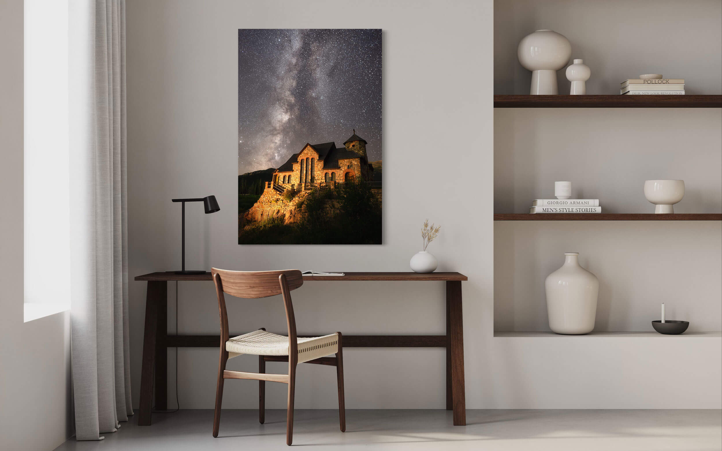 A piece of Colorado art showing the St. Malo's Chapel near Estes Park hangs in an office.