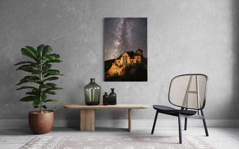 A piece of Colorado art showing the St. Malo's Chapel near Estes Park hangs in a living room.