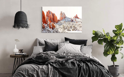 A piece of Colorado Springs art showing the Garden of the Gods in winter hangs in a bedroom.