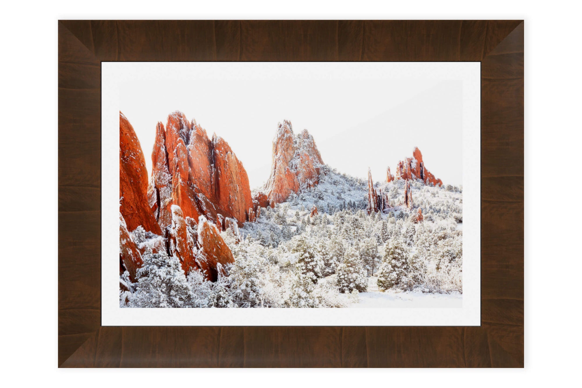 A piece of framed Colorado Springs art shows the Garden of the Gods in winter.