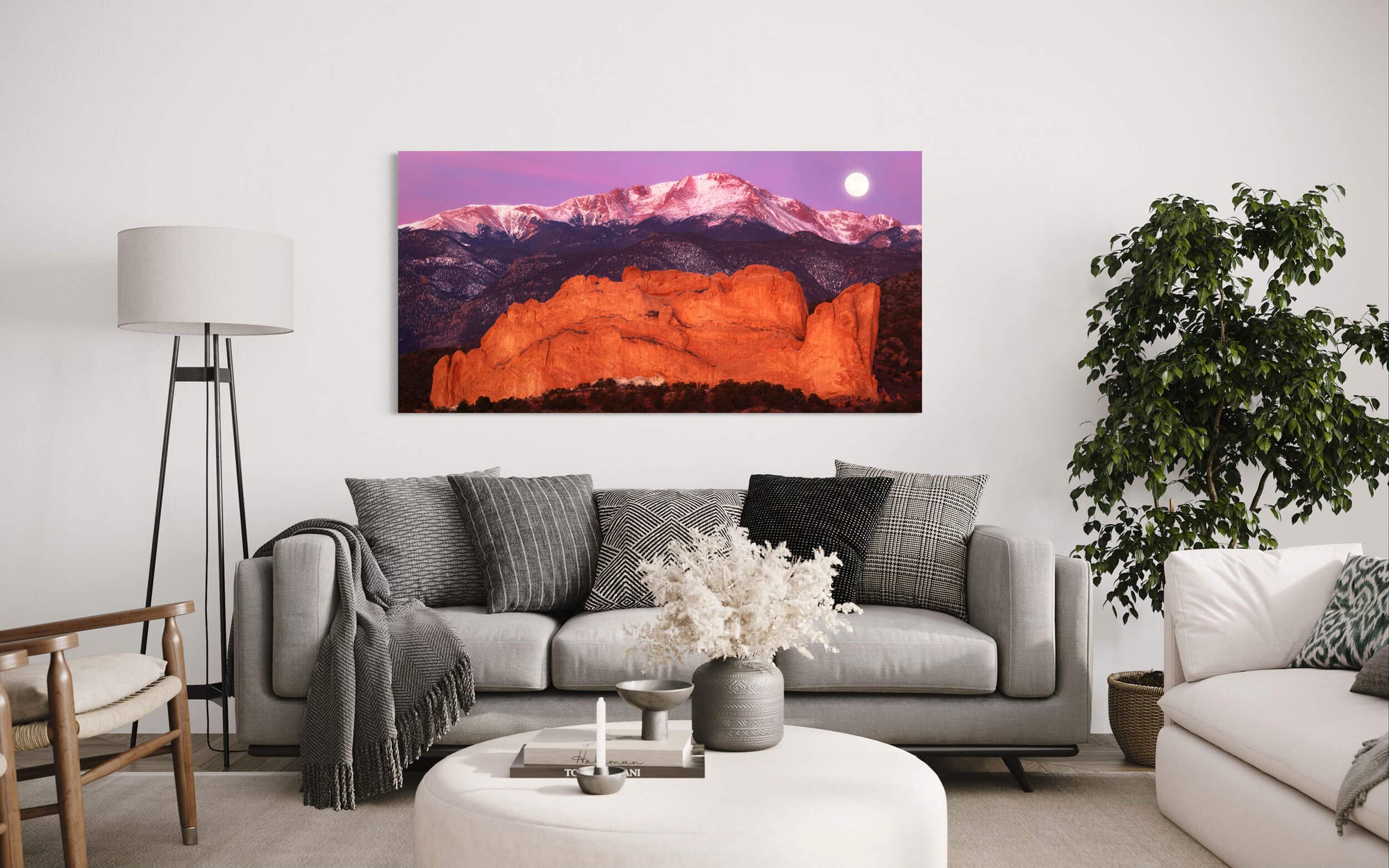A piece of Colorado Springs art showing Pikes Peak and Garden of the Gods hangs in a living room.