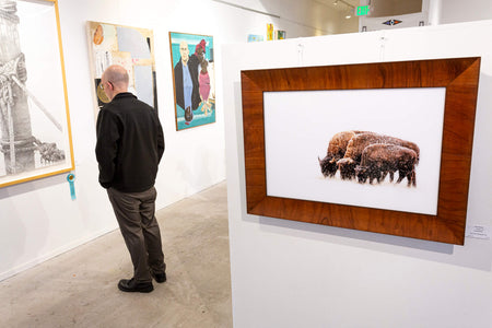 A picture of bison in the snow outside of Denver hangs in an art gallery.