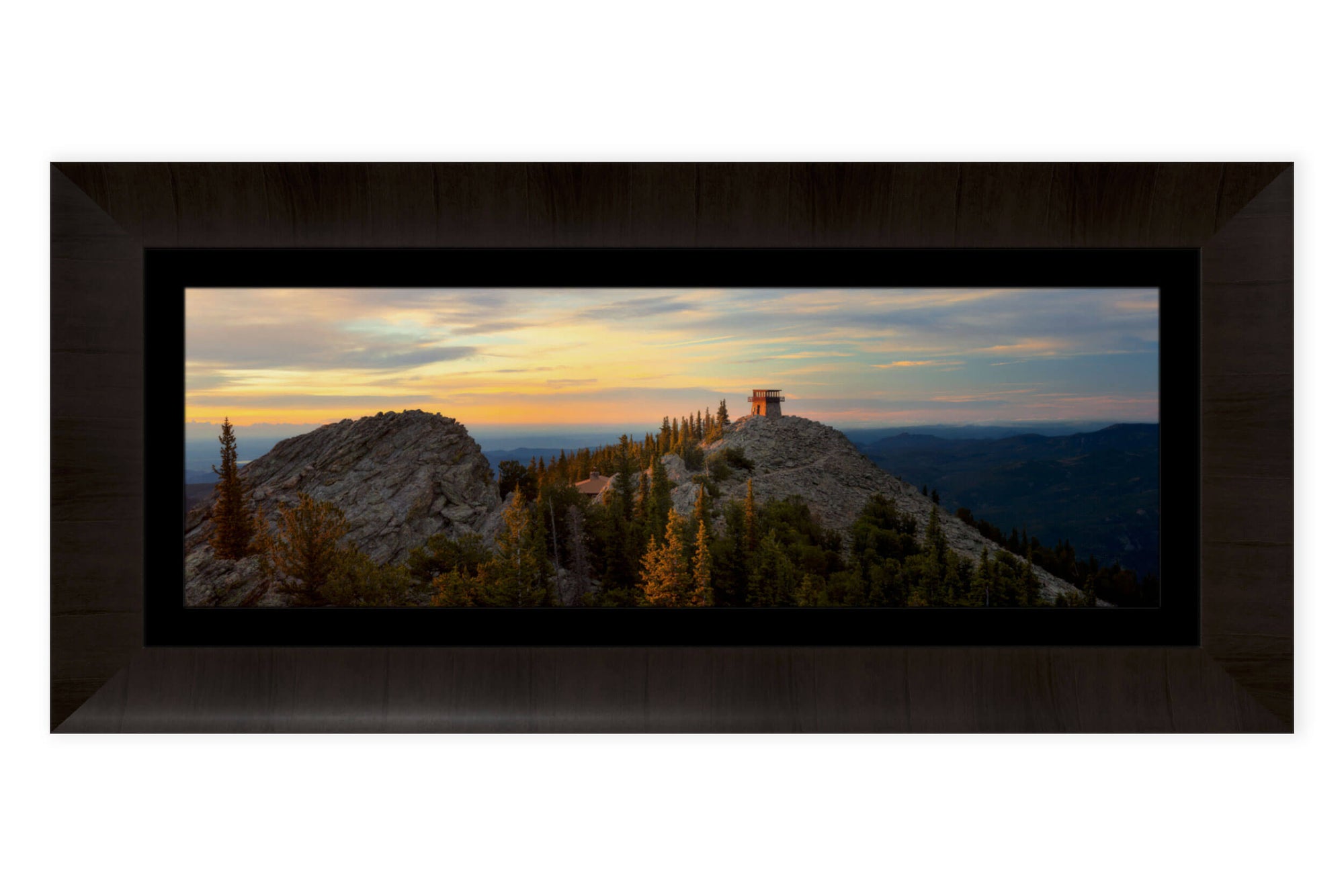 A piece of framed Denver art shows a fire lookout picture.