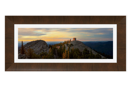 A piece of framed Denver art shows a fire lookout picture.