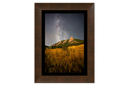 A piece of framed Boulder art shows the Flatirons in Colorado.