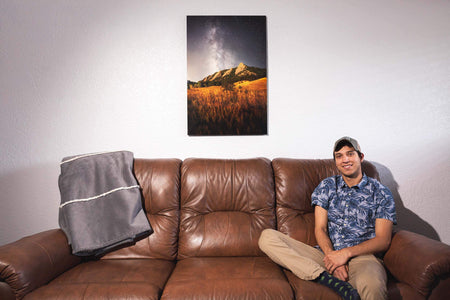 A piece of Boulder art showing the Flatirons in Colorado hangs in a collector's living room.
