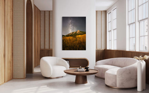 A piece of Boulder art showing the Flatirons in Colorado hangs in a living room.